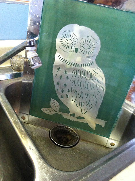 Screen, emulsion applied, dried, exposed to light with owl negative, and rinsed. Ready to print.